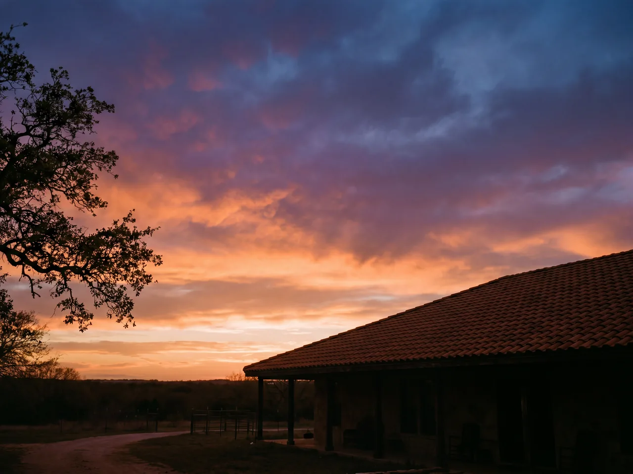 Spanish tile roofline of a Texas home at dusk
